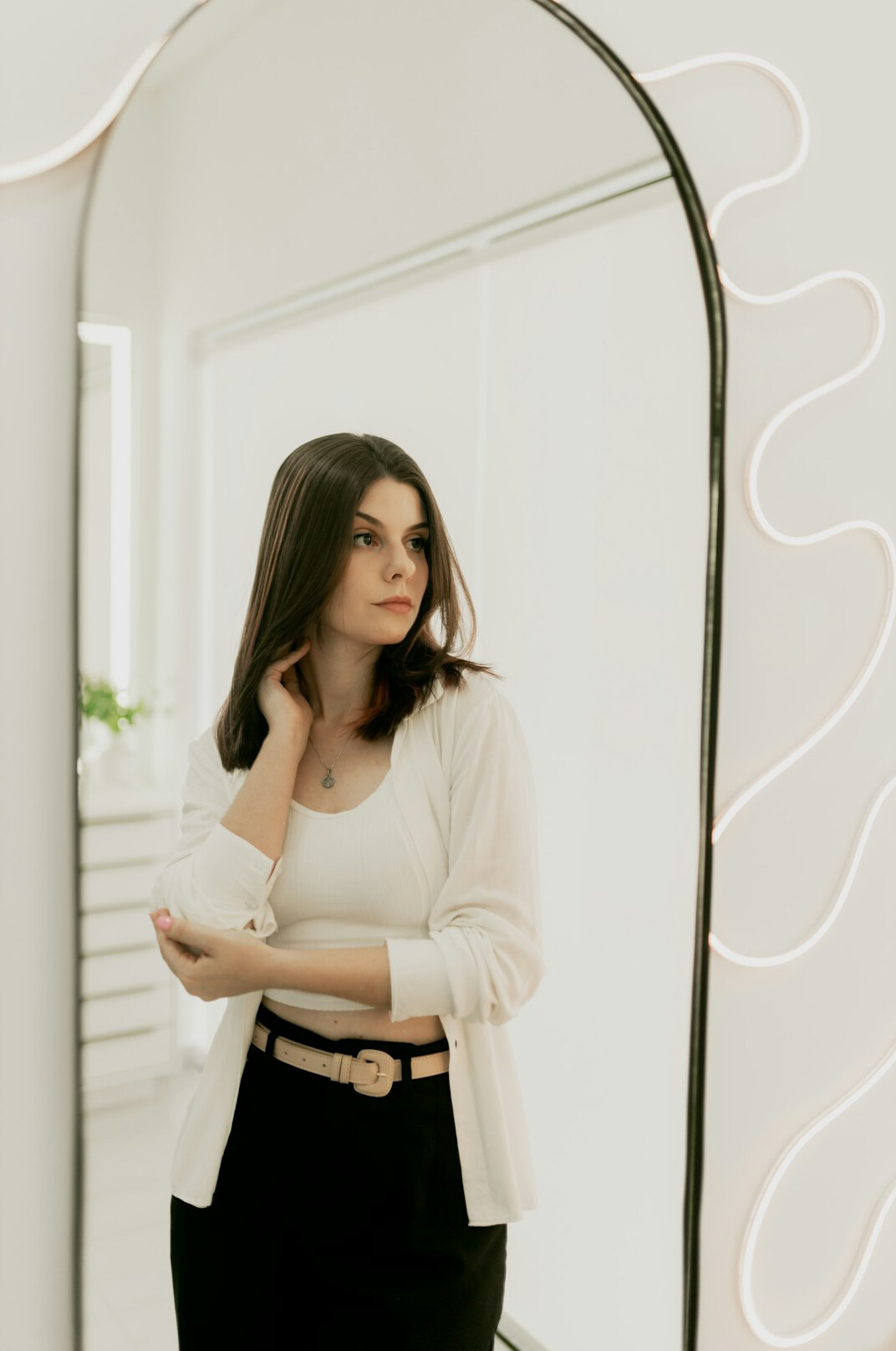Portrait of a smiling businesswoman with dark hair in a bright office