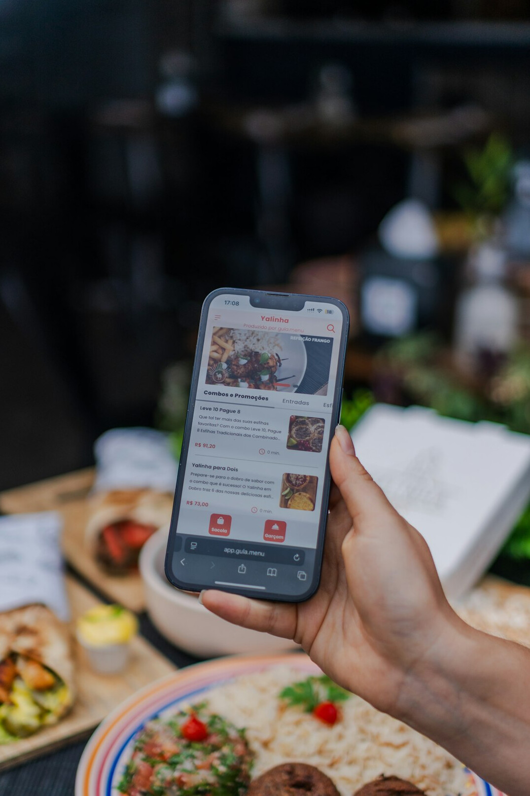 Hand holding a smartphone with a news feed